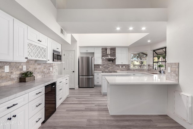 10338 E San Salvador Dr, Scottsdale, AZ 85258 - kitchen with stainless steel appliances, wall chimney exhaust hood, backsplash, a sink, and light countertops