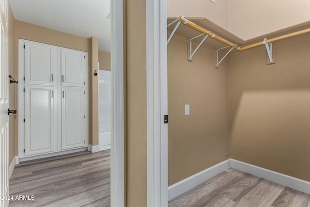 spacious closet with light hardwood / wood-style floors