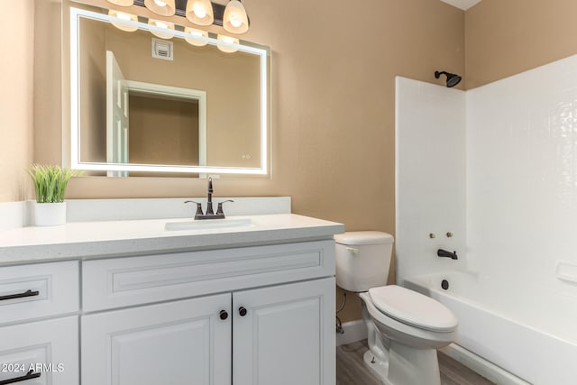 full bathroom featuring vanity, wood-type flooring, bathtub / shower combination, and toilet