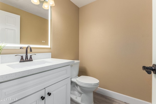 bathroom featuring hardwood / wood-style flooring, vanity, and toilet