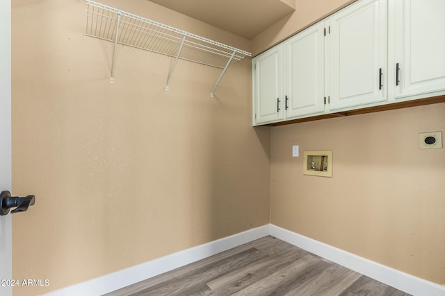 laundry room featuring cabinets, washer hookup, light hardwood / wood-style floors, and hookup for an electric dryer