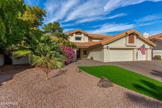 10338 E San Salvador Dr, Scottsdale, AZ 85258 - mediterranean / spanish home with stucco siding, a garage, driveway, and a tiled roof