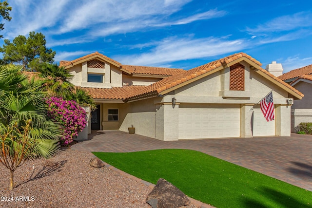 10338 E San Salvador Dr, Scottsdale, AZ 85258 - mediterranean / spanish-style home with stucco siding, a garage, decorative driveway, and a tiled roof