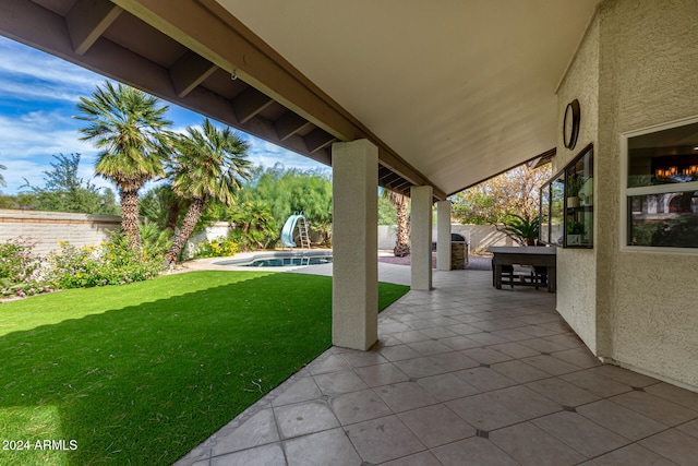 view of patio with a fenced in pool