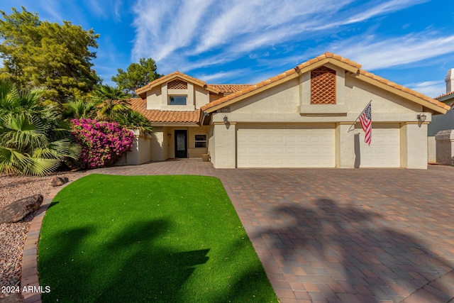 10338 E San Salvador Dr, Scottsdale, AZ 85258 - mediterranean / spanish home with stucco siding, a garage, decorative driveway, and a tile roof