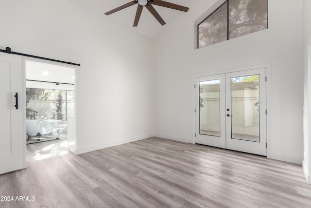 10338 E San Salvador Dr, Scottsdale, AZ 85258 - unfurnished living room with high vaulted ceiling, a ceiling fan, french doors, wood finished floors, and baseboards