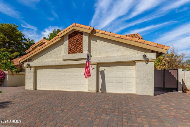 10338 E San Salvador Dr, Scottsdale, AZ 85258 - garage with decorative driveway and a gate