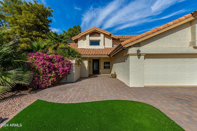 10338 E San Salvador Dr, Scottsdale, AZ 85258 - view of front of property with stucco siding, an attached garage, a tile roof, and decorative driveway