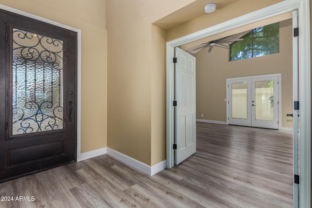 foyer with hardwood / wood-style floors, french doors, and ceiling fan