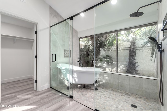 10338 E San Salvador Dr, Scottsdale, AZ 85258 - bathroom with a stall shower, a freestanding bath, wood finished floors, a walk in closet, and baseboards