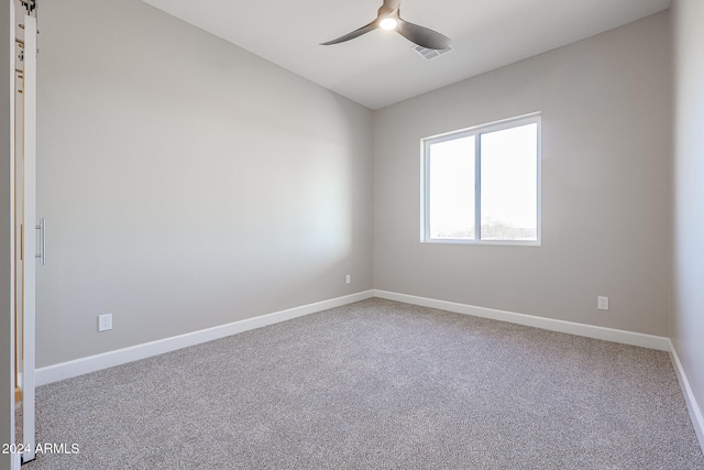 empty room with ceiling fan and carpet floors