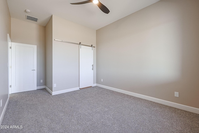 unfurnished bedroom featuring ceiling fan, a closet, and carpet floors