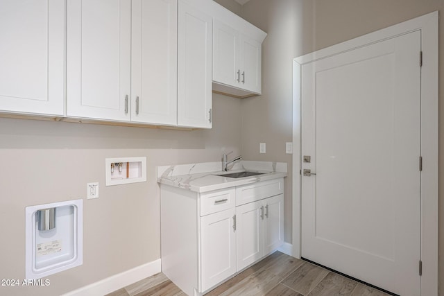 laundry room with sink, cabinets, light wood-type flooring, and washer hookup