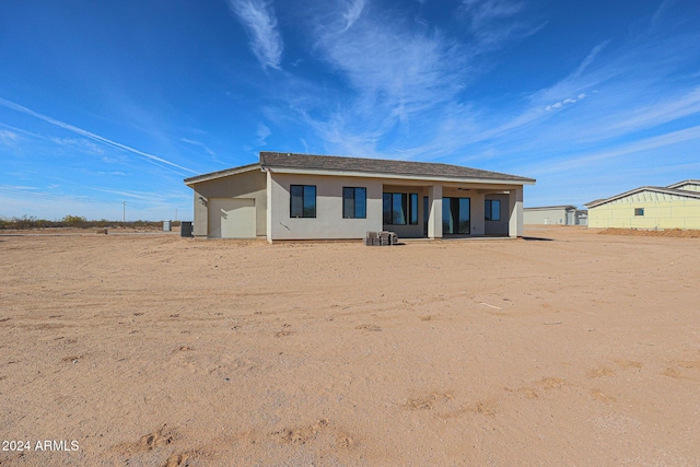 rear view of property featuring a garage