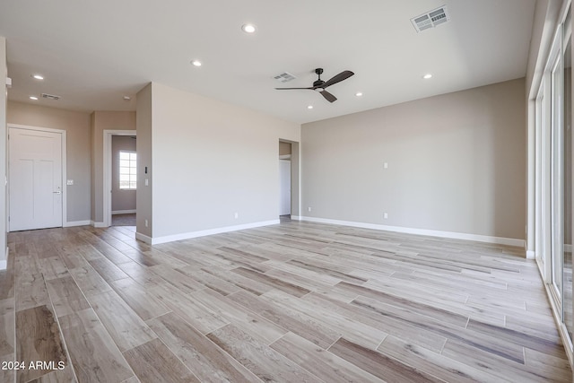 spare room featuring light hardwood / wood-style floors and ceiling fan