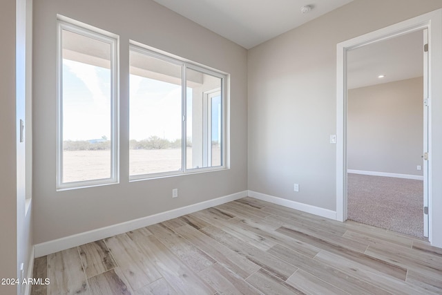 empty room with light hardwood / wood-style flooring and a healthy amount of sunlight