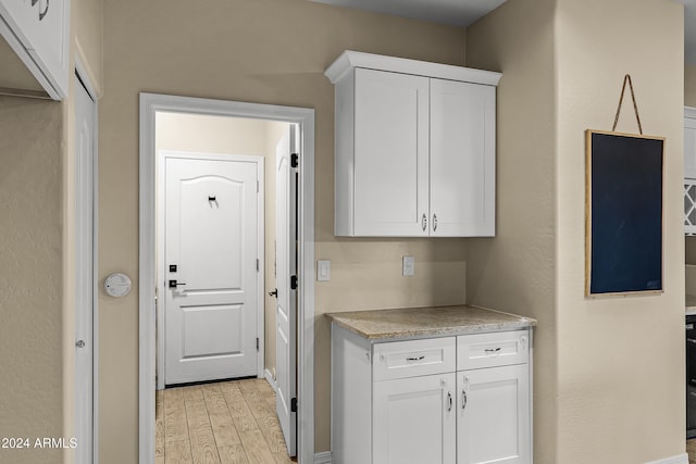 kitchen featuring white cabinets and light hardwood / wood-style floors