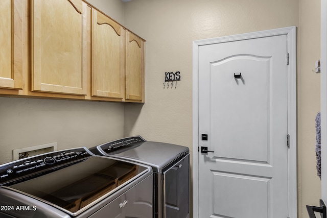 washroom with cabinets and independent washer and dryer