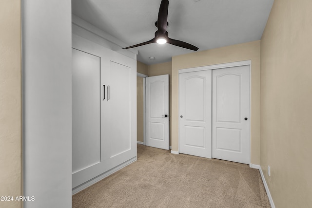 unfurnished bedroom with light carpet and ceiling fan