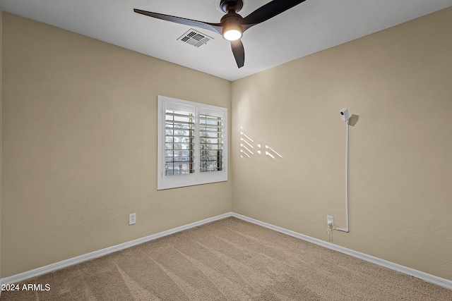 carpeted spare room featuring ceiling fan