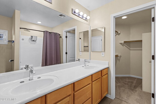 bathroom with vanity, tile patterned floors, and walk in shower