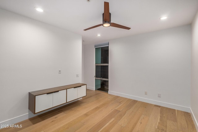 empty room with baseboards, light wood-type flooring, a ceiling fan, and recessed lighting