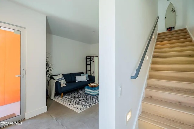 stairway with concrete flooring