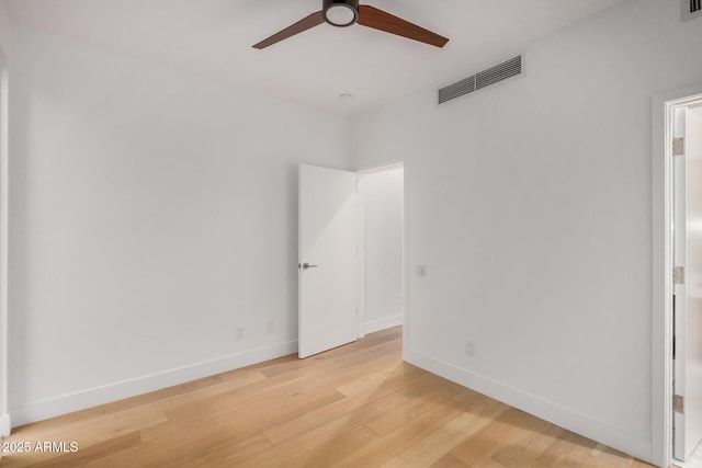 unfurnished bedroom featuring light wood finished floors, a ceiling fan, visible vents, and baseboards