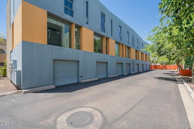 view of building exterior with community garages