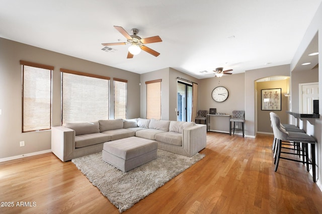 16600 N Thompson Peak Pkwy Unit 2006, Scottsdale, AZ 85260 - living area with a ceiling fan, arched walkways, baseboards, and light wood-style flooring