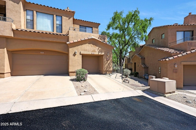 16600 N Thompson Peak Pkwy Unit 2006, Scottsdale, AZ 85260 - view of front of property with a balcony, stucco siding, concrete driveway, a tiled roof, and an attached garage