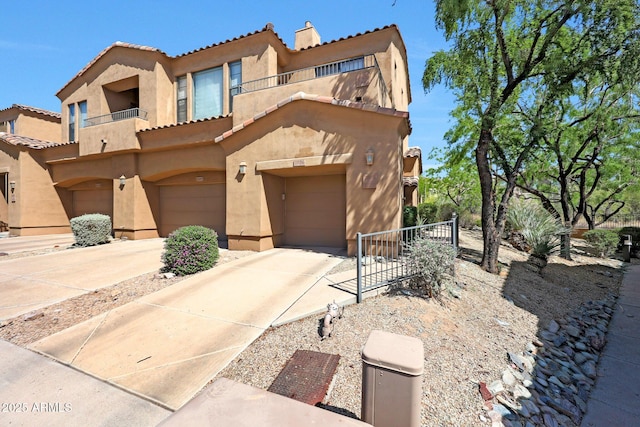 16600 N Thompson Peak Pkwy Unit 2006, Scottsdale, AZ 85260 - view of front of house featuring stucco siding, a balcony, a tile roof, and an attached garage