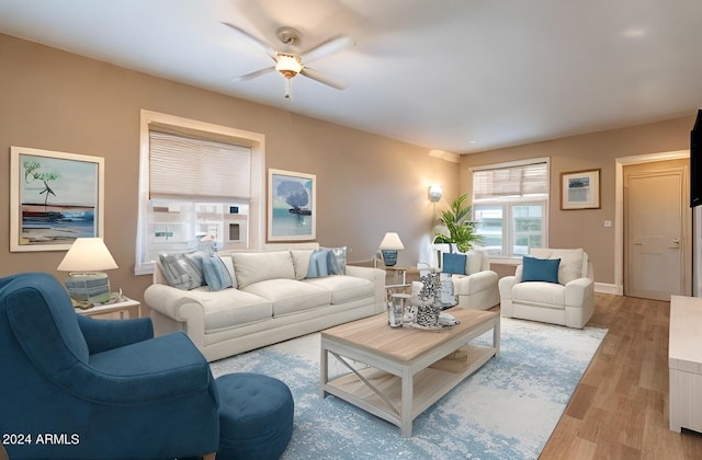 living room with ceiling fan and light hardwood / wood-style floors