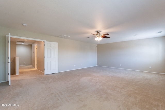 unfurnished room with ceiling fan and light colored carpet