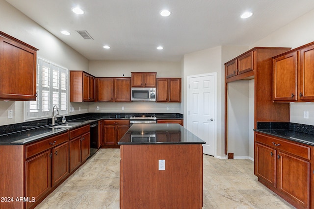 kitchen with a kitchen island, dark stone countertops, appliances with stainless steel finishes, sink, and light tile floors