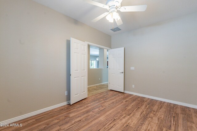 unfurnished room featuring hardwood / wood-style flooring and ceiling fan