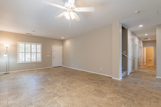 spare room featuring ceiling fan and light tile floors