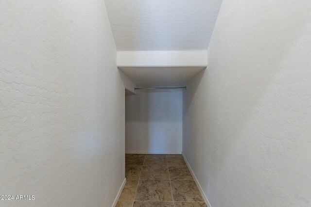 hallway with tile flooring