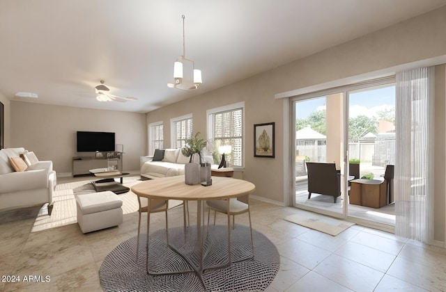 living room with ceiling fan with notable chandelier and light tile floors