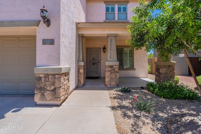 view of exterior entry featuring a garage