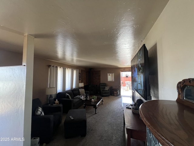 carpeted living room featuring a textured ceiling