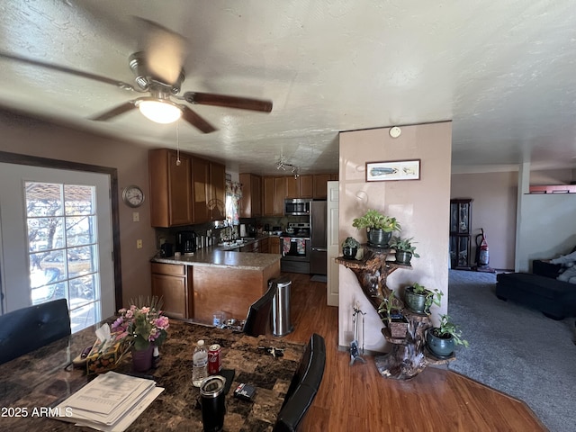 dining area with a textured ceiling, dark hardwood / wood-style floors, ceiling fan, and sink