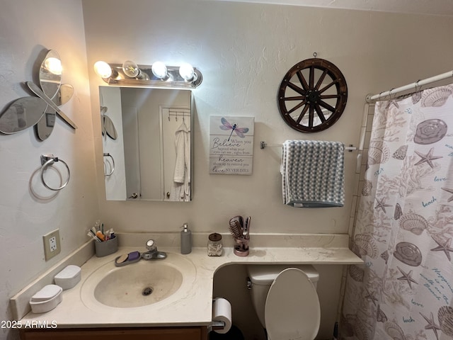 bathroom featuring vanity, toilet, and curtained shower