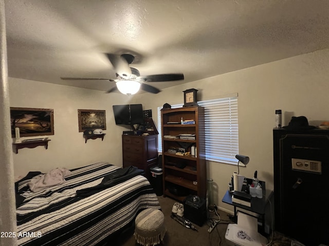 carpeted bedroom featuring a textured ceiling and ceiling fan