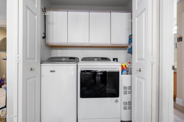 laundry area with cabinets and independent washer and dryer