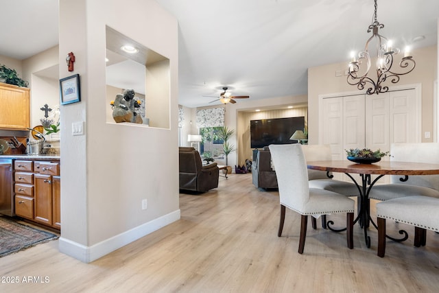 dining space with ceiling fan and light hardwood / wood-style flooring