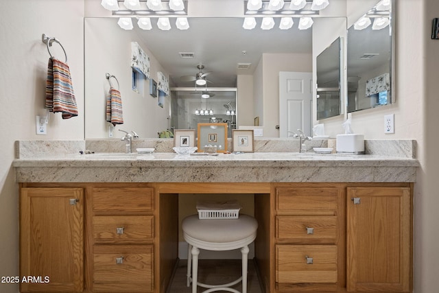 bathroom featuring a shower with door and vanity