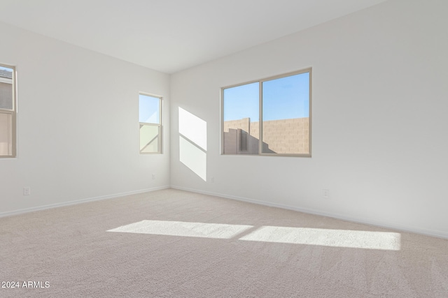 unfurnished room featuring light colored carpet