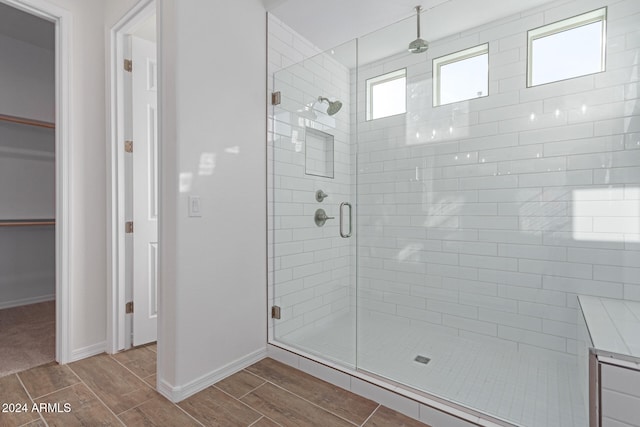 bathroom with a shower with door