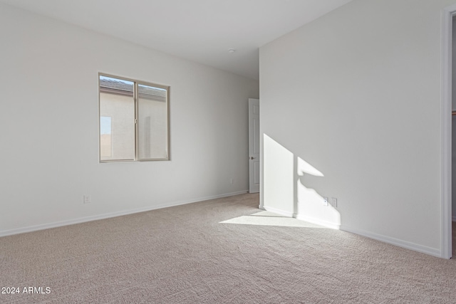 empty room featuring light carpet